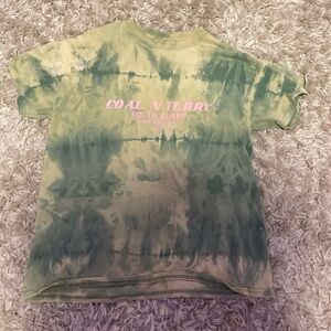 medium in women’s green and tan tie-dye shirt.